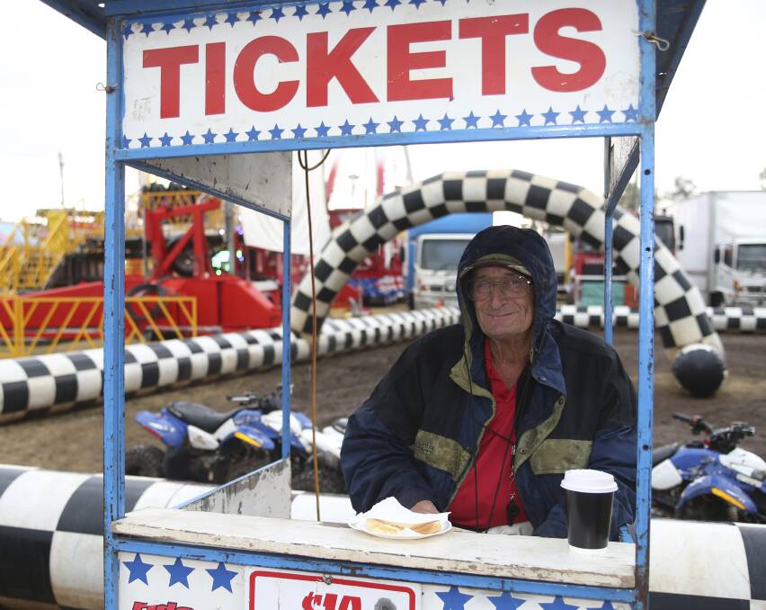 ROLL UP: Ticket vendor William Shakespeare waits in the rain for some daring participants to take a quad bike for a spin in the mud.