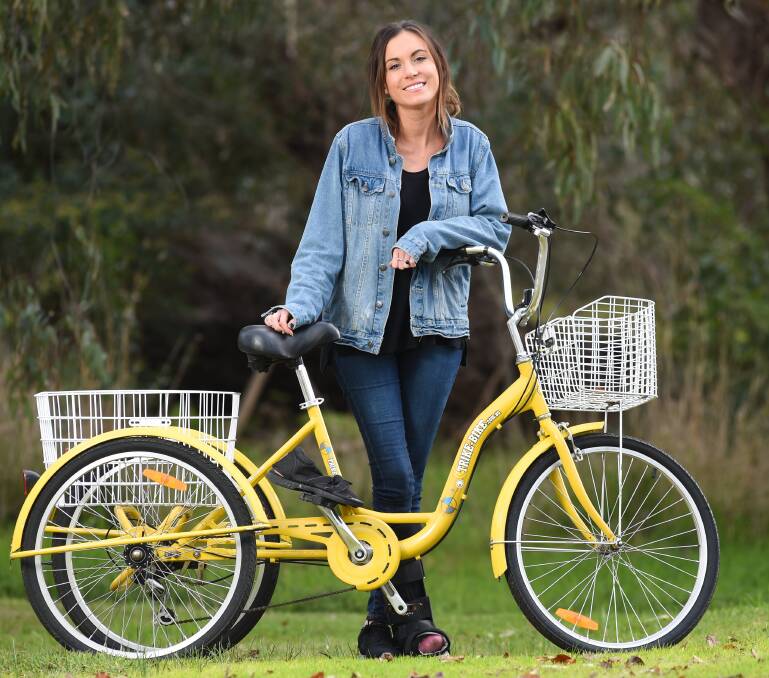 REHAB MACHINE: Emily with her new trike, named Lemon. Picture: MARK JESSER