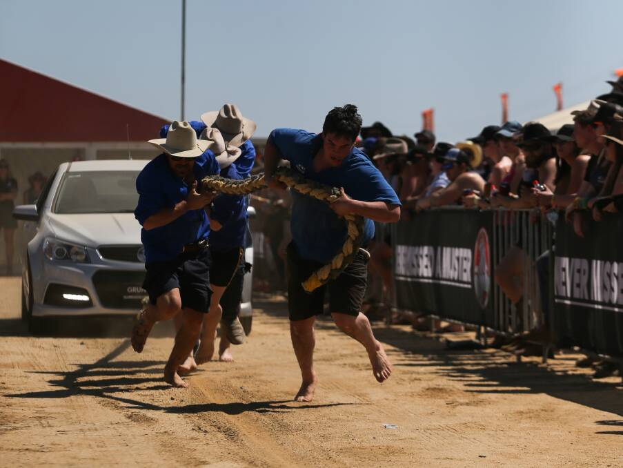 RUNNING BARE: Shoes weren't a requirement in the Grunt Off car pulling event where contestants were more focused on getting to the finish line.