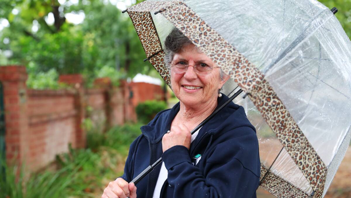 BRING AN UMBRELLA: Krysia Szkiela from Canberra was prepared for the wet weather yesterday. Picture: Emma Hillier