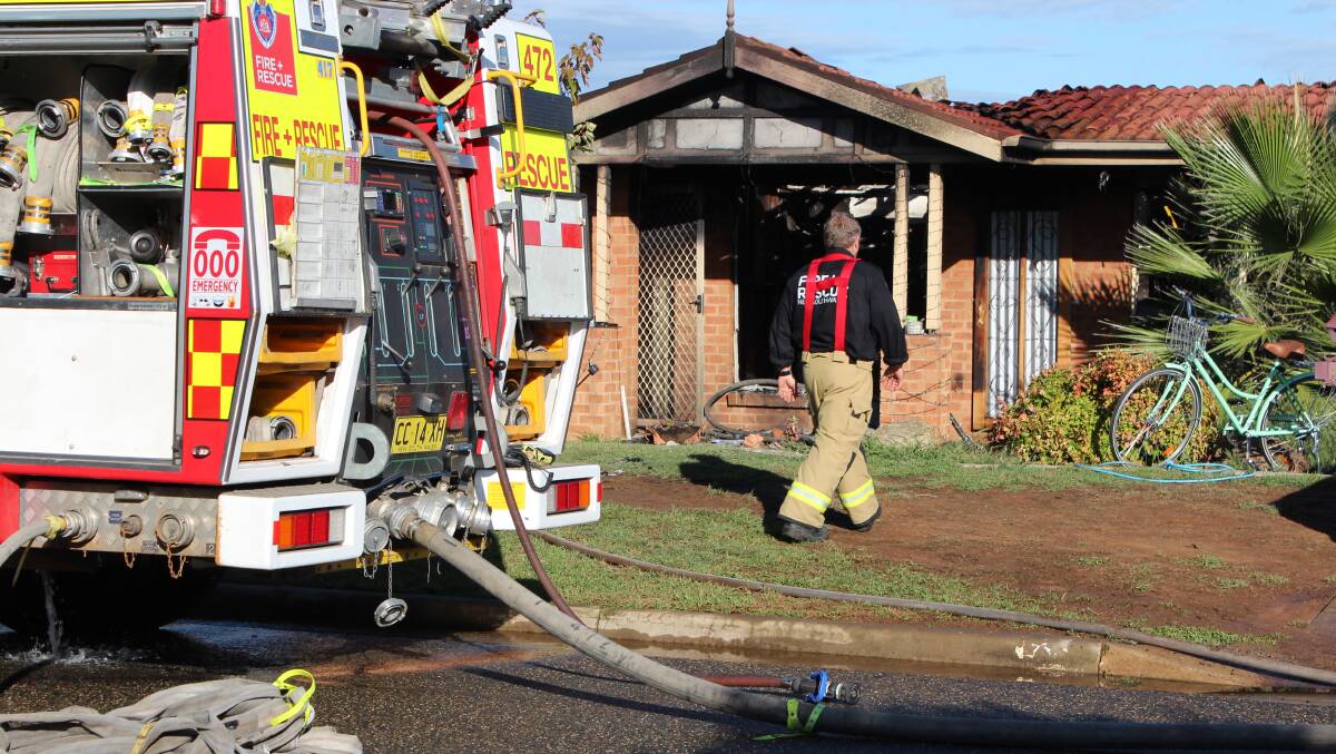 FIRE: Crews attend the fire on Saturday morning which rendered the house uninhabitable. Picture: Emma Horn