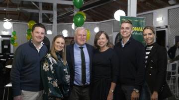 Michael McCormack with wife Catherine, daughter Georgina and Georgina's partner Daniel Bell (left) and son Alex and Alex's partner Jemma Yates celebrate at Wagga's Murrumbidgee Turf Club after declaring victory in the Riverina in the 2022 federal election. Picture: Madeline Begley.