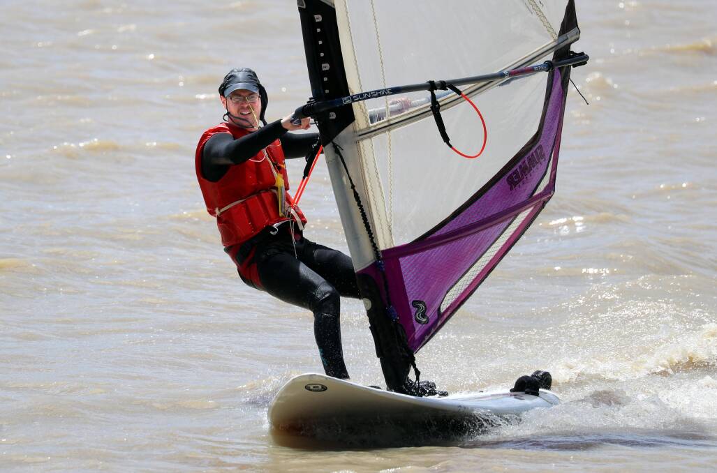 KEEPING COOL: The blustery and windy conditions on the second day of summer were ideal for Leonard Wilson, who took his windsurfer to Lake Albert for a few laps around the pond. Picture: Les Smith