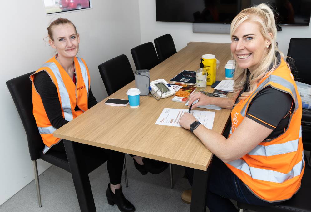 Ellen (left) with a Health in Gear nurse for a free health check at Ron Finemore Transport Wodonga. Picture supplied.