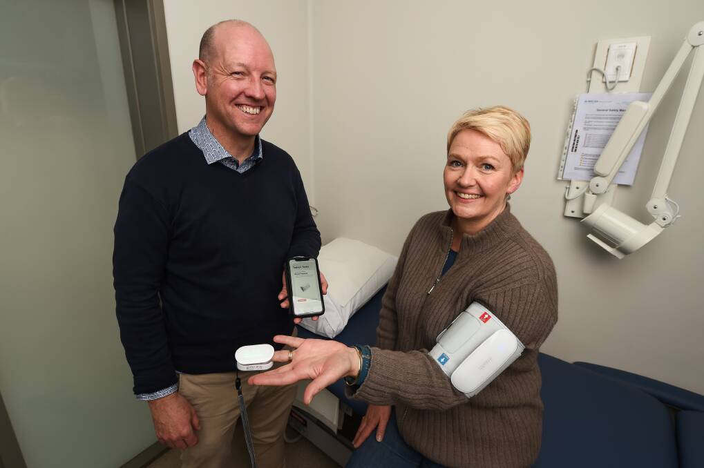 HEALTH GADGETS: Propell chief executive Craig Simmonds shows Beechworth Surgery complex care co-ordinator Caroline Ashcroft how to use the iHealth devices for a trial of the technology. Picture: MARK JESSER