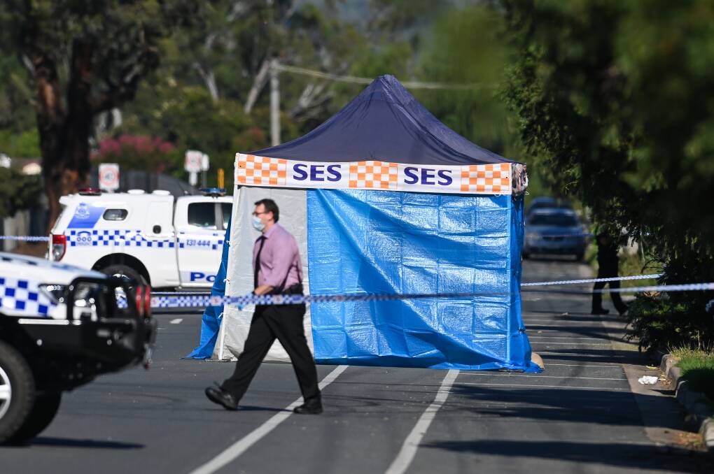 CRIME SCENE: Police block off a section of Woodland Street as they continue their investigations on Sunday morning. Picture: MARK JESSER
