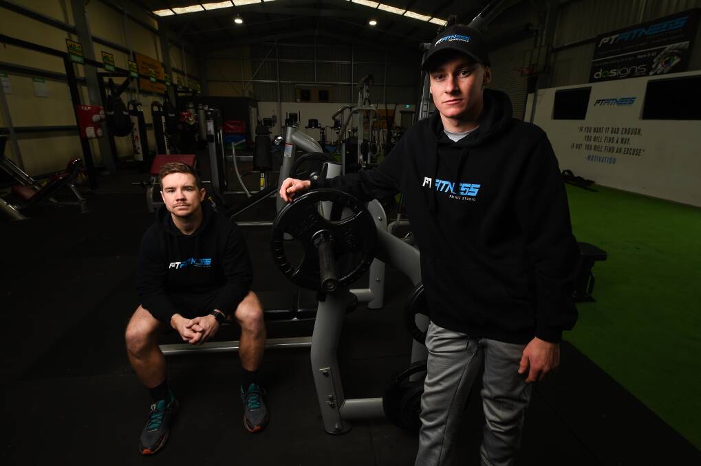 BACK IN GAME: PT Fitness gym trainers, Joel OConnell and Nathan Rodgers, will welcome members back on Monday. Picture: MARK JESSER
