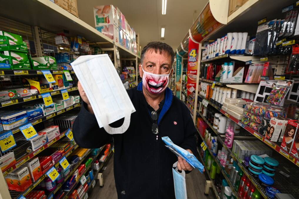 Not masking his opinion: IGA owner Gary Evans with face coverings being sold at his Norris Park store, though he does not believe they are necessary in regional NSW. Picture: MARK JESSER