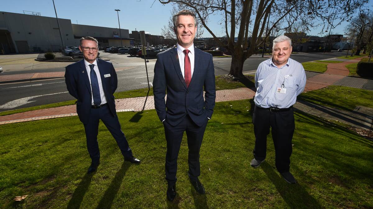 FUNDS: Graeme Simpfendorfer with Tim Griffiths of North East Health and Michael Kalimnios of Albury Wodonga Health. Picture: MARK JESSER