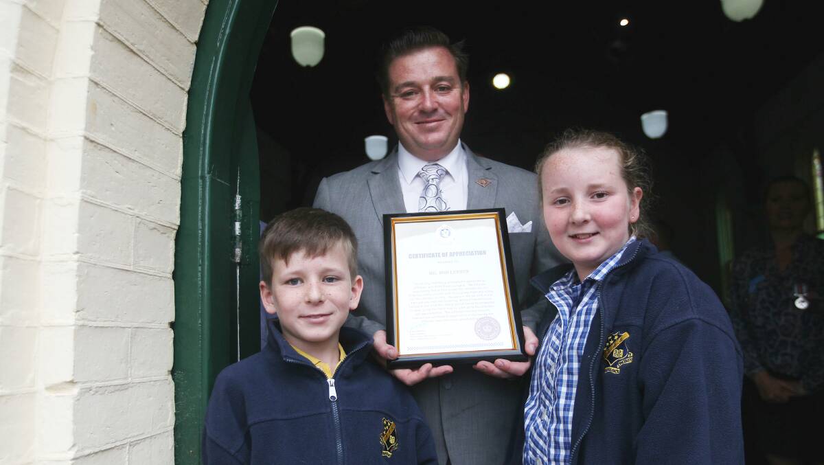 PROUD MOMENT: Rob Lennon with children Jack and Hannah at the Albury Police Station church yesterday after receiving a certificate of commendation from NSW Police during the annual awards ceremony.