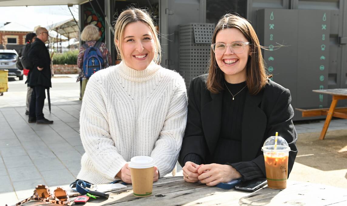DOING OK: Carers Amy Connelly, 29, and Tiffany McFadzean, 30, treat themselves to a $7 cup of coffee at Junction Square. Pictures: MARK JESSER
