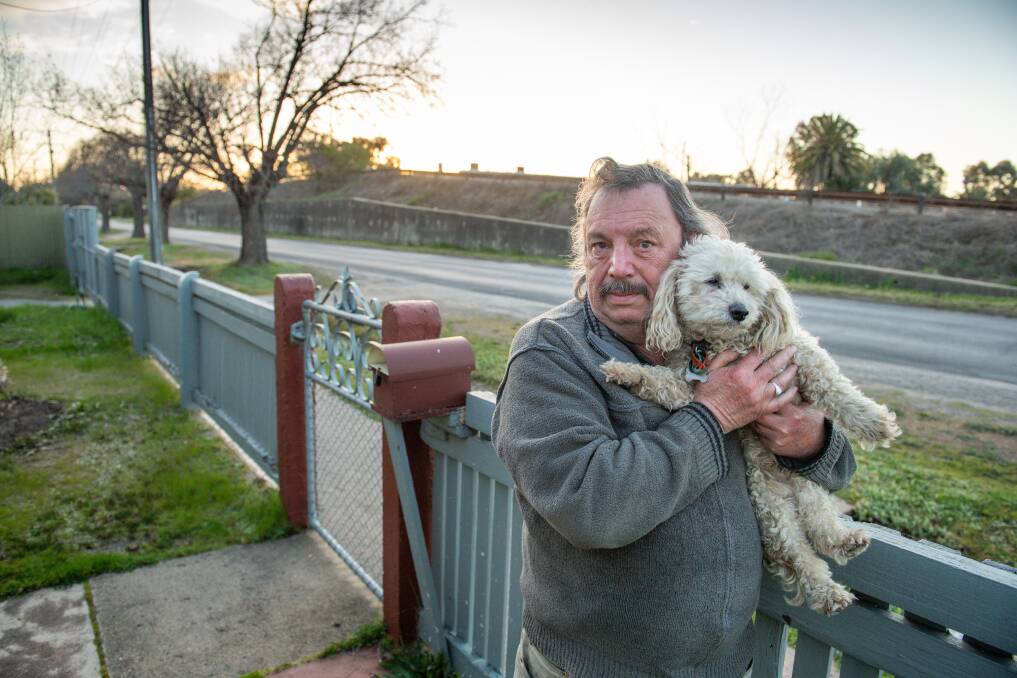 BIG PROBLEM: Murray Smith, with 'Bluey', says he's come to terms with the existing overpass but plans for a new one will block the sun and be an eyesore.