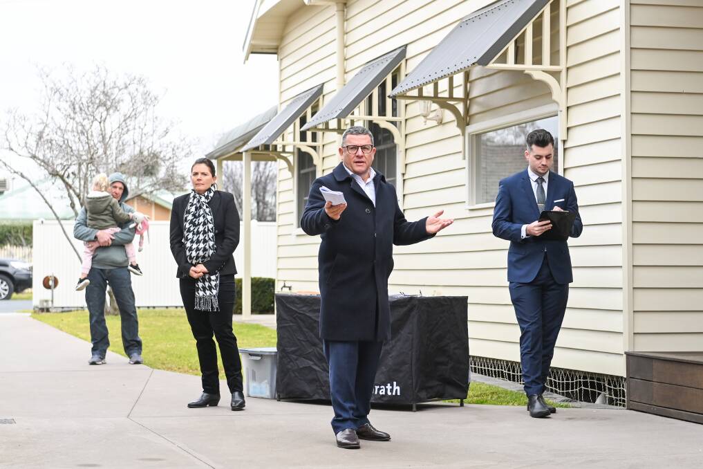 MAKE ME AN OFFER: McGrath Real Estate's Philip Bell calls for bids for 2 Wilson Street in Wodonga on Saturday. The property attracted interest of more than $1 million and sold after auction for an undisclosed fee. Picture: MARK JESSER