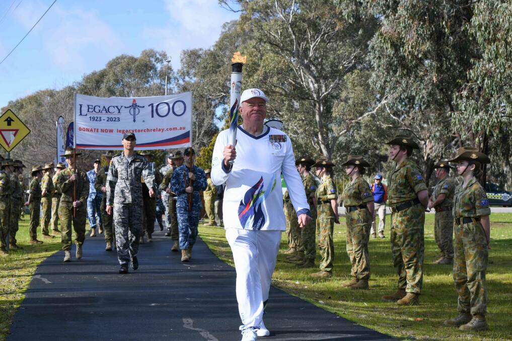 First torch bearer for Wodonga, Robin Patterson, marches from Bandiana Army Museum. Picture by Tara Trewhella
