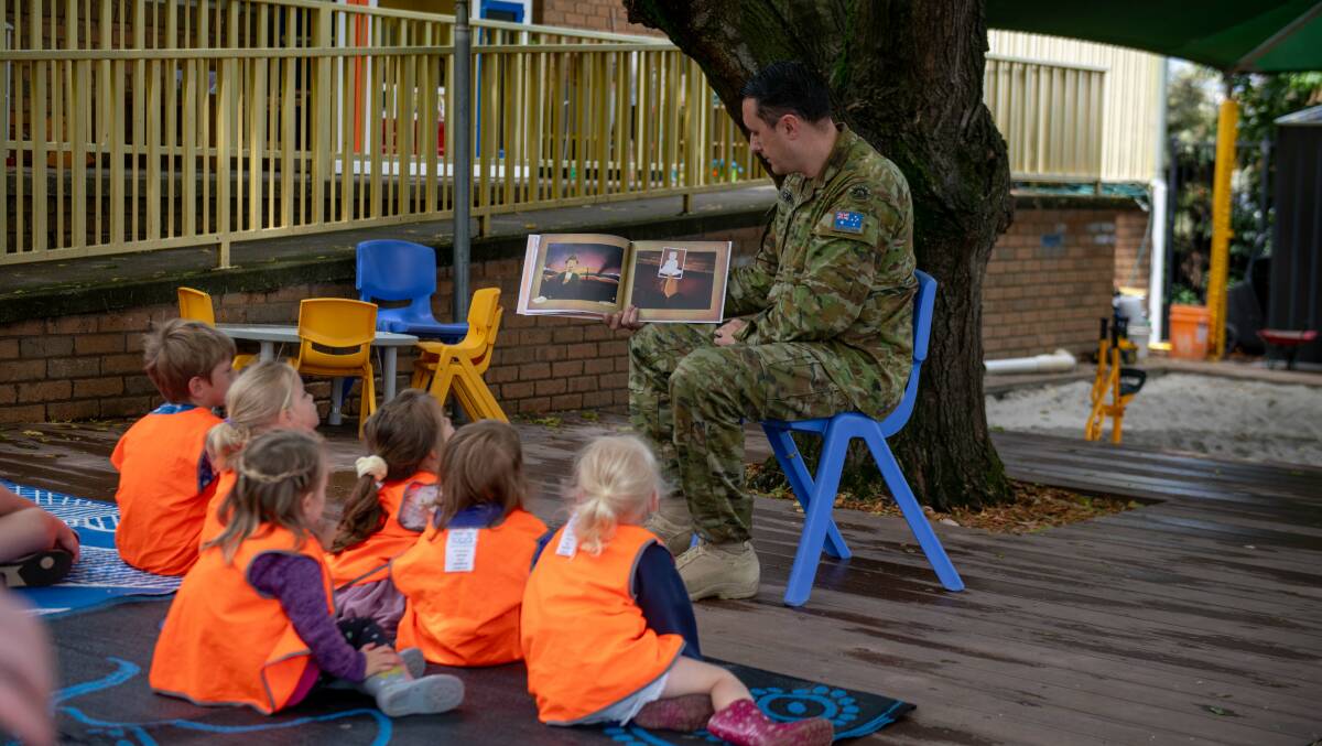 Major Mark Robinson reads 'Lest We Forget' to the children. Picture by Tara Trewhella.