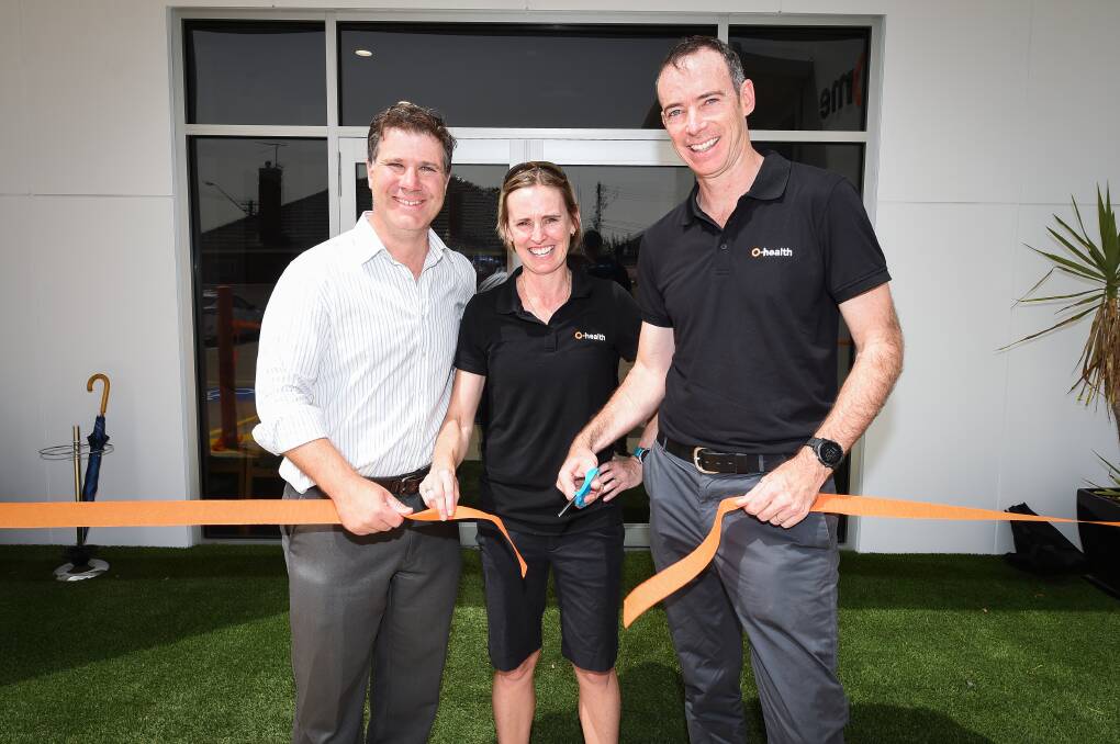 ORANGE: Member for Albury Justin Clancy helped cut the ribbon with Lisa and Tom Barry. Picture: MARK JESSER