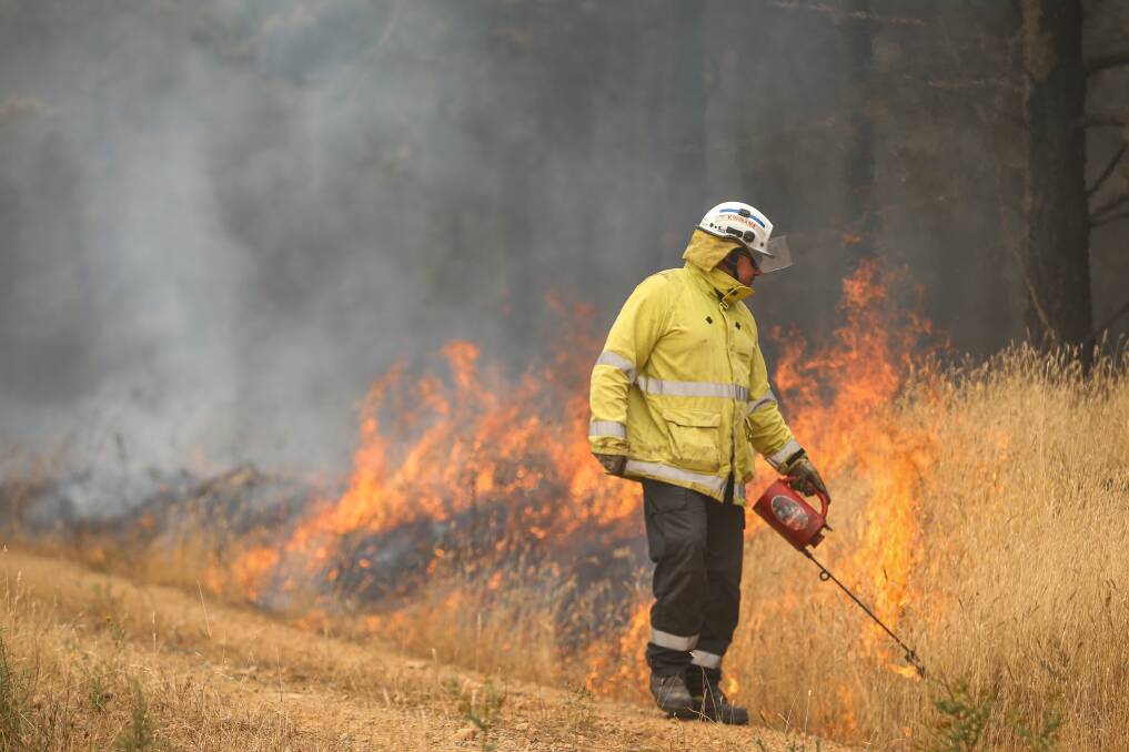 FLAMES: The Western Australian Strike Team were a part of some back burning north of Jingellic yesterday aiming to strengthen containment lines. Pictures: JAMES WILTSHIRE