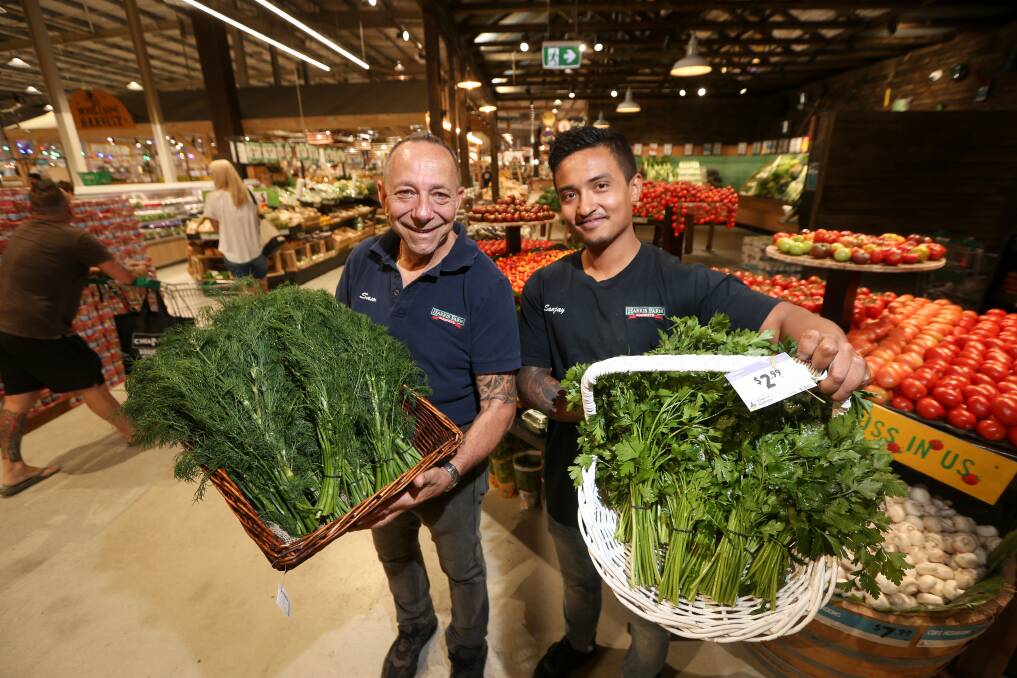 EXCITEMENT: Harris Farm Albury store manager Sam Fuda with worker Sanjay Munankarmi. The grocer has been open for two weeks and hasn't slowed down since launching on the Border on January 29. Picture: JAMES WILTSHIRE