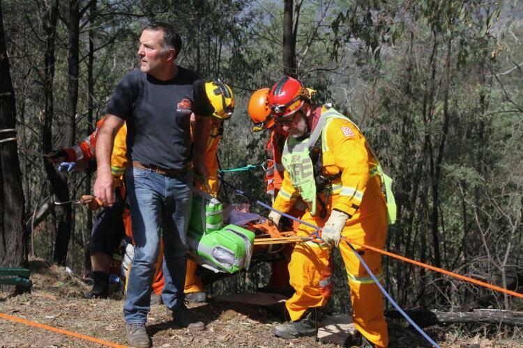 LUCKY ESCAPE: SES and CFA members took 45 minutes to rescue the motorbike rider near Bright on Saturday. Picture: CFA