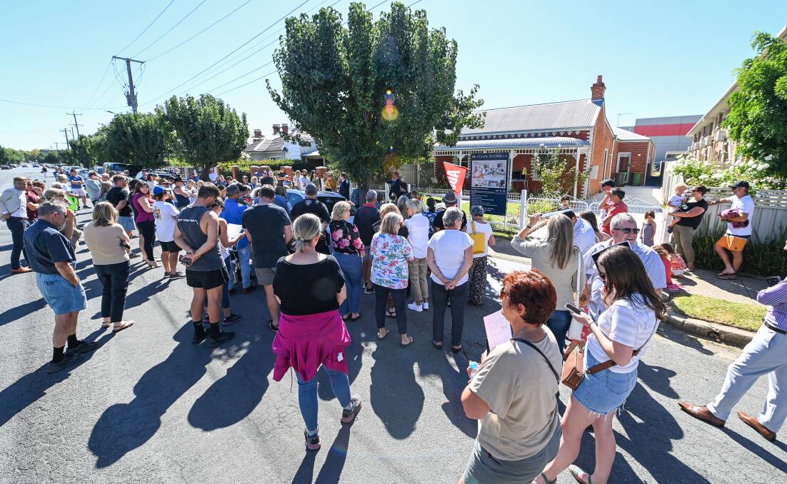 CROWD: More than 100 on-lookers and interested buyers spilled onto the road for the Saturday morning auction. Picture: MARK JESSER