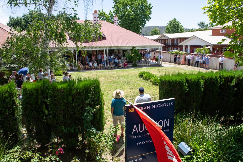BIG TURN OUT: Around 50 onlookers attended the auction at 595 Kiewa Street on Saturday to see what the old home would sell for. Despite multiple registered bidders, the property was passed in at $975,000. Picture: MARK JESSER