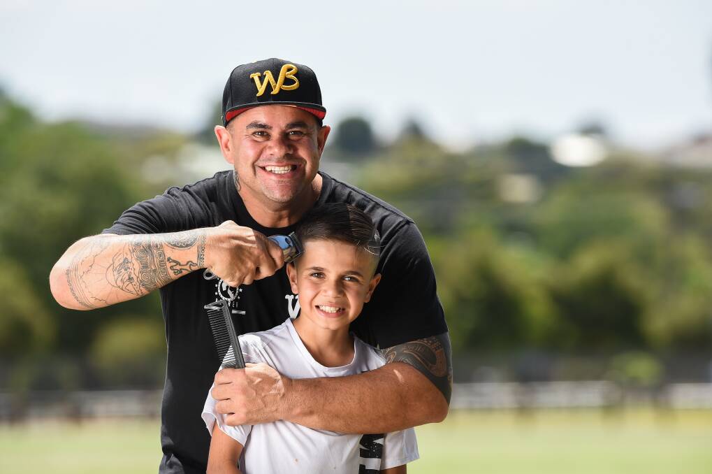 FRESH CUTS: Walkabout Barber founder Brian Dowd with 11-year-old Kaeleb Willard-Reid from Wodonga in Lavington on Wednesday. Picture: MARK JESSER