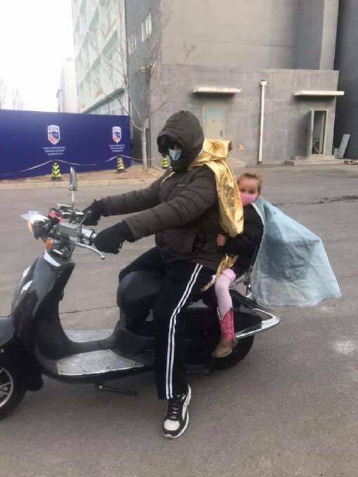 OTHER SIDE: Korey Livy entertains his four-year-old daughter Vivienne by pretending to be superheros on the streets of Beijing. 