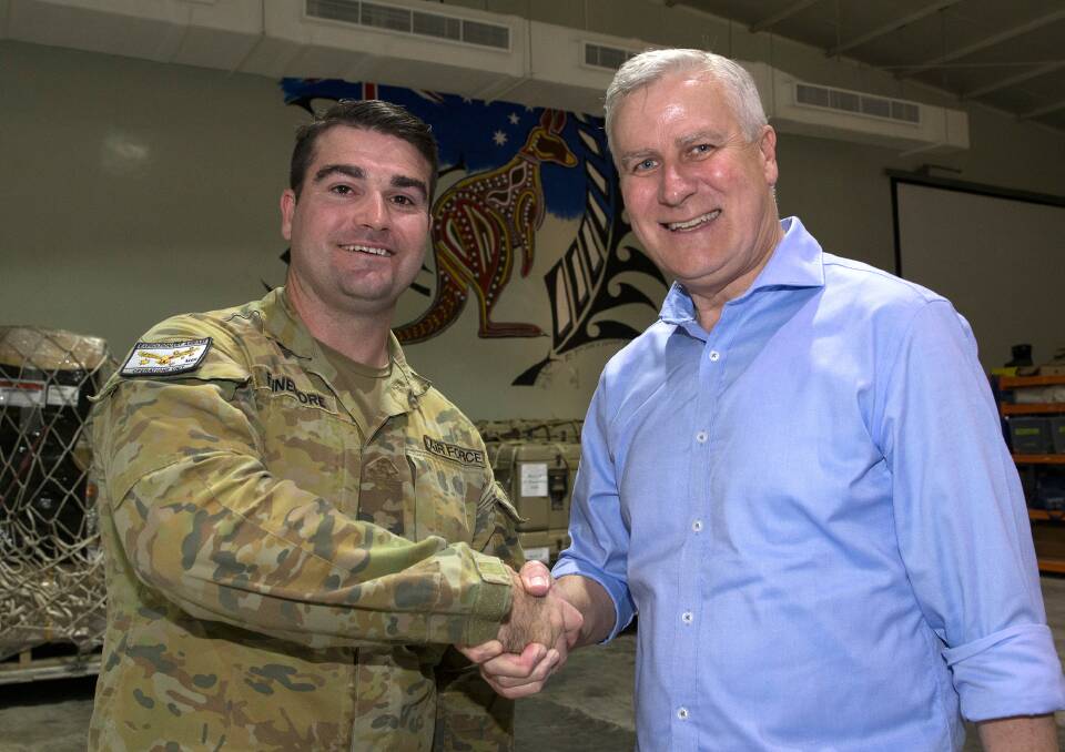 PROMOTION: Corporal Matthew Finnemore receives his new rank from Deputy Prime Minister Michael McCormack in the Middle East. Picture: KIRK PEACOCK