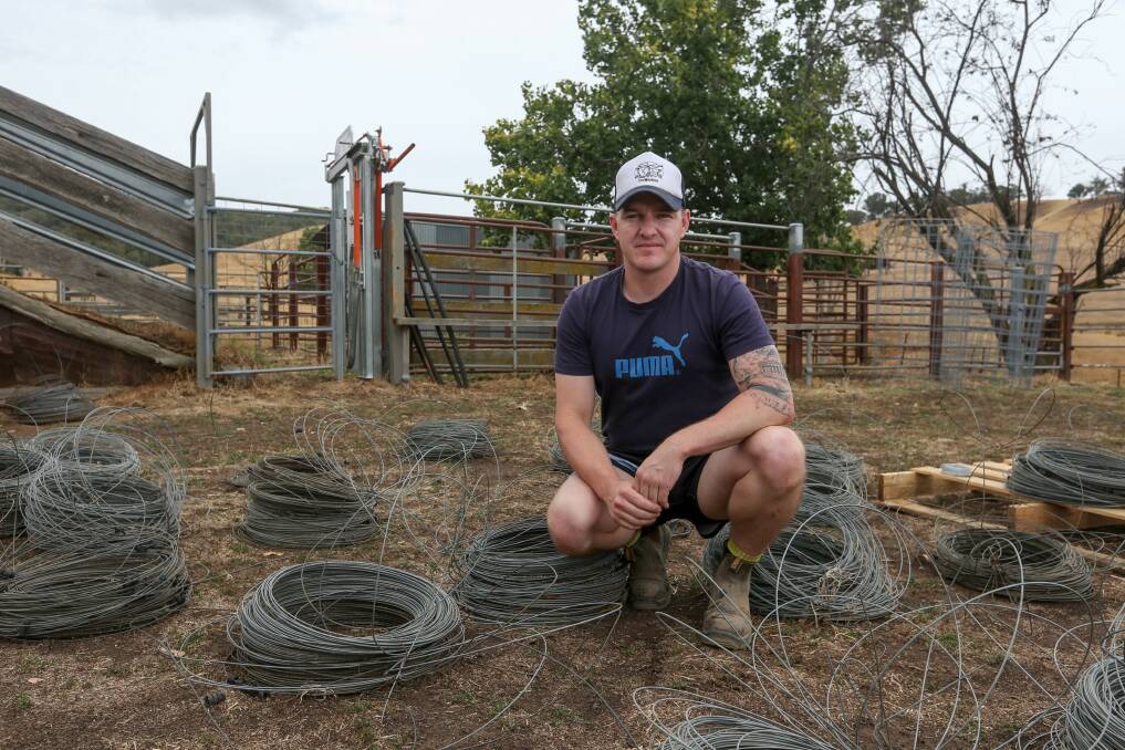 HELPING HAND: Jamie Wolf, supported by his father Alex and friends, started the Fencing For Fires group after the Upper Murray bushfires, and said the community's Aussie spirit shone through. Picture: TARA TREWHELLA
