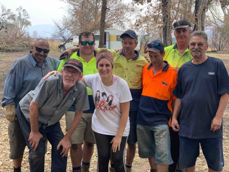 HELPING OUT: Dwayne Health (centre) with a team of tradie mates who have been installing temporary showers and water tanks in Corryong and surrounds for the past two weeks.