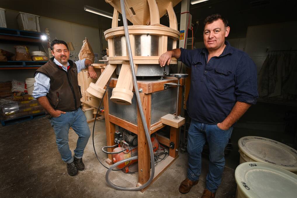 COLAB: Milawa Bread's Adam Rivett and Clear Creek Pastoral Co's Andrew Freshwater with one of the hand-made flour mills operating in Milawa. The pair are working together to grow grain locally. Picture: MARK JESSER