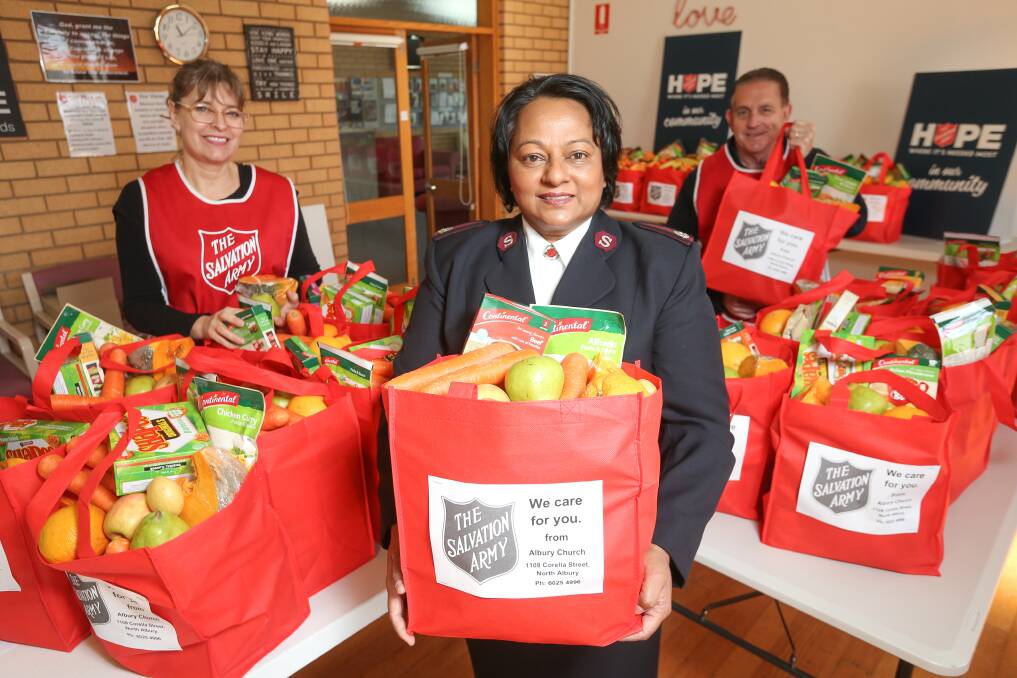 CARE PACKS: Major Phillip Pleffer, Major Irene Pleffer and volunteer Cherie Shepherd put together 100 care packs for vunerable people in the Albury area. Picture: JAMES WILTSHIRE