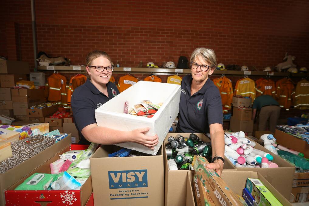 DONATIONS: Volunteers Samantha Young and Marg Tanner sort through donations at the Lavington Rural Fire Brigade. Picture: JAMES WILTSHIRE
