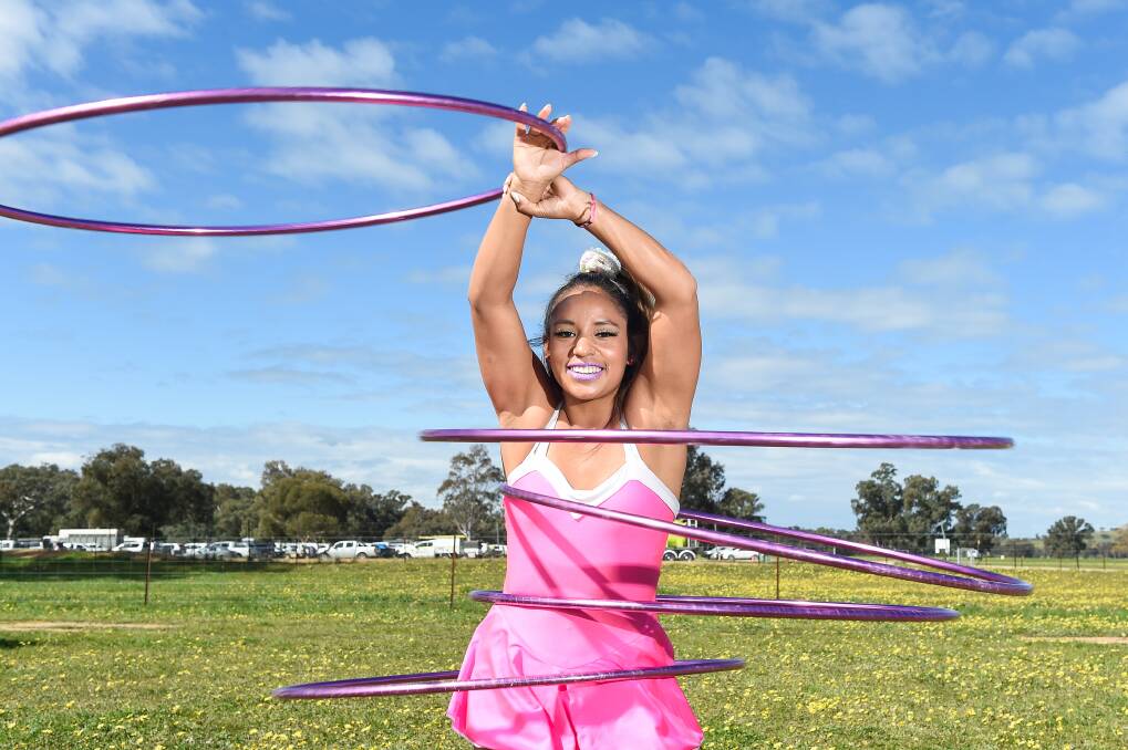 HOOPING GOOD TIME: Henty's own Marcela Scheuner performs each day of the field days after flying back home from a travelling circus. Picture: MARK JESSER