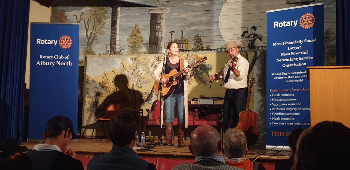 FOR THE FARMERS: Local performers Pete Denahy and Sara Storer entertained the crowd at the Pleasant Hills Hall after the barbecue dinner.