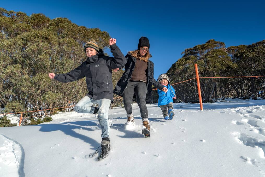 JUMPING FOR JOY: Matt Darby, 13, Gemma Garrity and Jack Winter, 2, can't wait for opening weekend at Falls Creek Picture: NATHAN FENTON