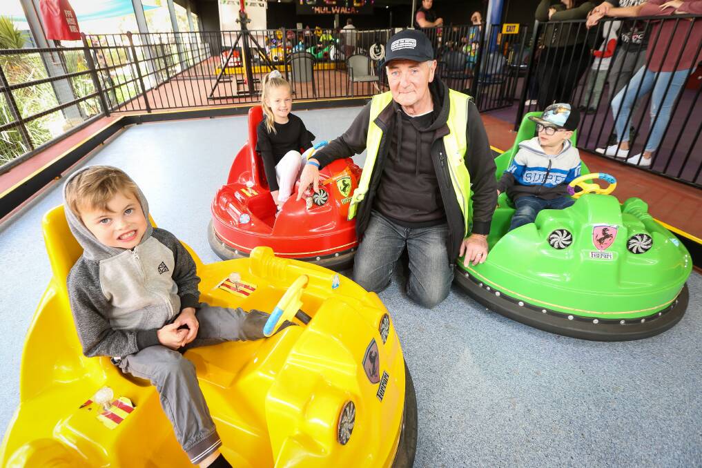 IN FULL SWING: Tunzafun's Phil Bott with Declan Cox, 6, Delta Bacon, 6, and Oliver Bacon, 5, enjoying some new rides. Picture: JAMES WILTSHIRE