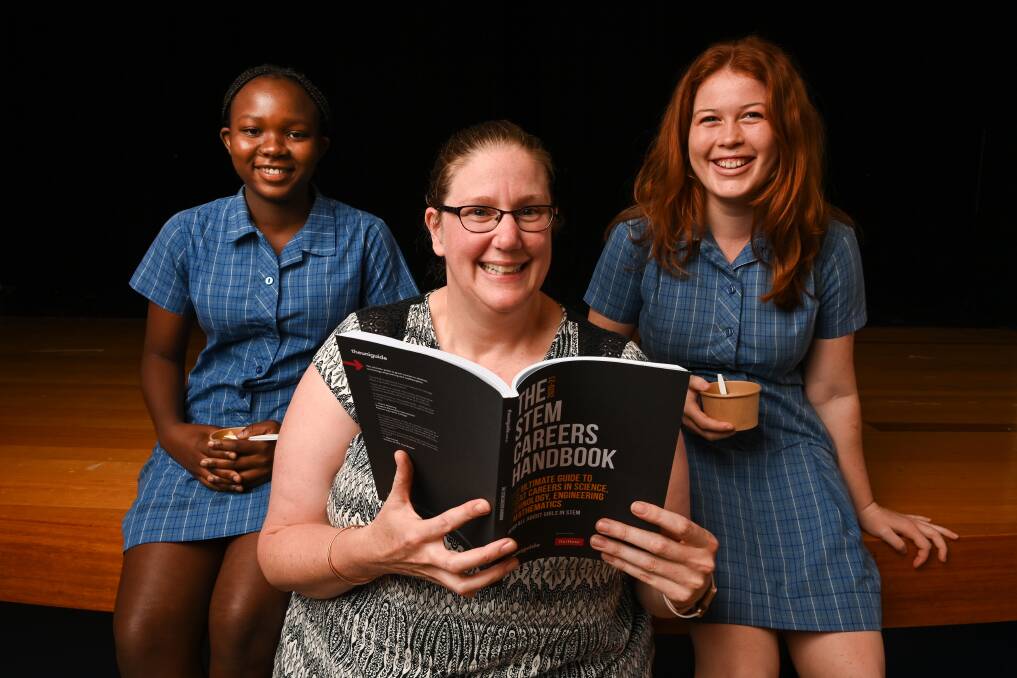 INSPIRATION: Catholic College Wodonga year 11 sudents Tafadzwa Mutape, 15, and Belle Smyth, 16, learnt all about La Trobe University's Dr Cathryn Hogarth's love of science on Thursday. Picture: MARK JESSER