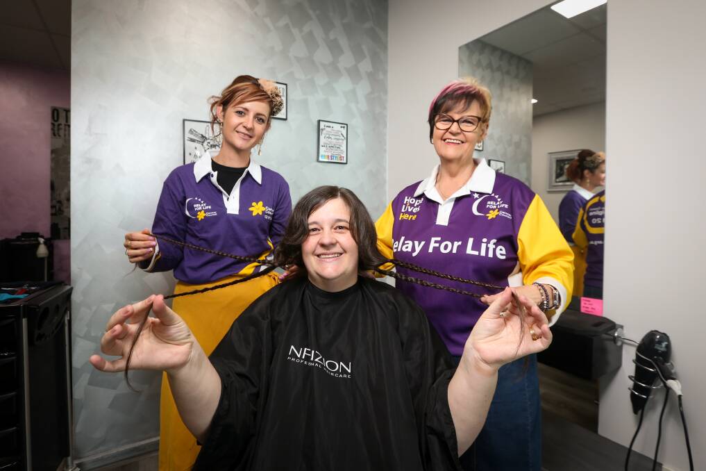 HERO: Border Relay for Life 2020 Hero Julie Collis (right) with daughters, Liz Pieper (hairdresser) and Penny Litchfield who donated her hair on Friday. Picture: JAMES WILTSHIRE