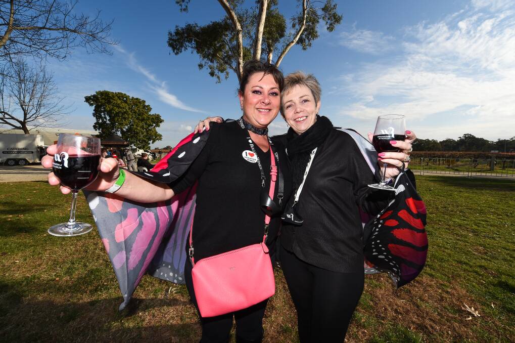 CHEERS: Natalie Roksandic and Helen King from Corowa enjoying the sun at Campbell's Wines on Sunday. Pictures: MARK JESSER