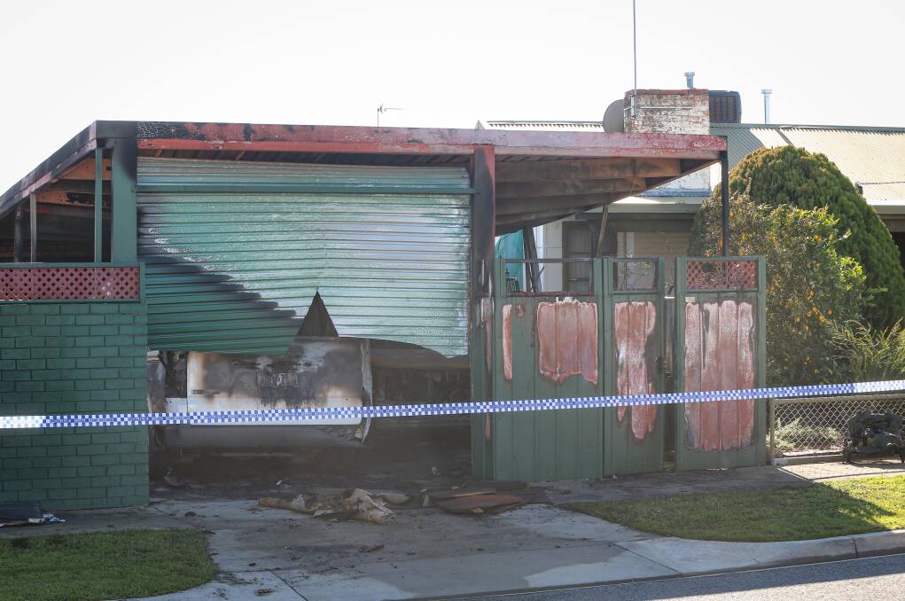 SHED FIRE: Several cars were severely damaged in the blaze, which destroyed the Higgins Street property's back shed. 