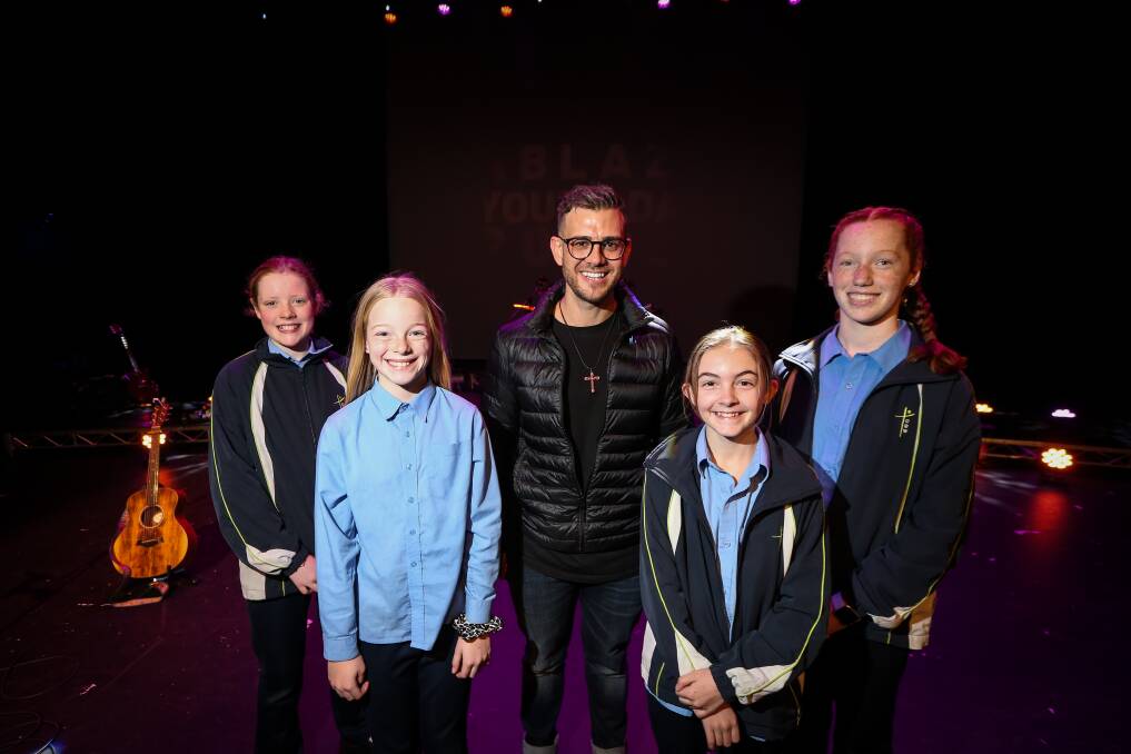 YOUTH FESTIVAL: Ruby Wilson, 12, Faith Delaney, 11, Ella Wall, 12 and Yvette Ennis, 11, St Monica's Primary School students with Fr Rob Galea. Picture: JAMES WILTSHIRE