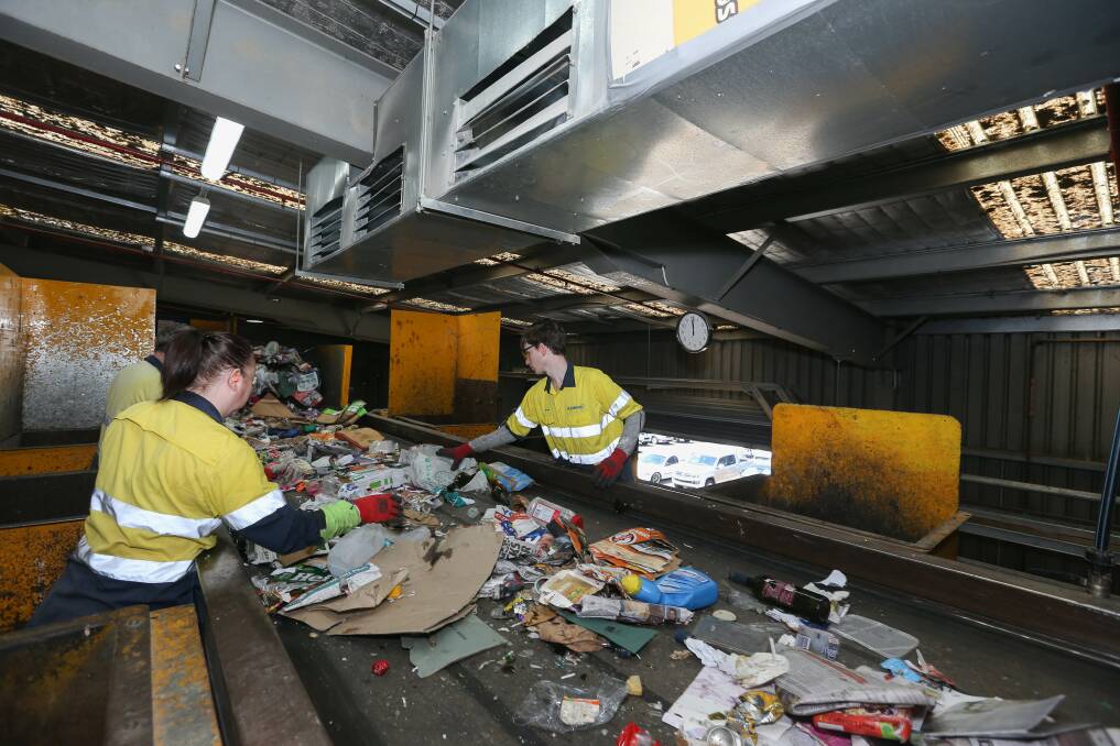 SORTING: Staff at the Cleanaway Albury Material Recovery Facility sort through waste and remove any contamination materials such as plastic. Picture: TARA TREWHELLA