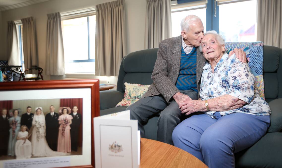 WEDDED BLISS: Stanley and Kathleen Lechmere celebrate 70 years of marriage with a kiss and cuddle yesterday. Picture: JAMES WILTSHIRE