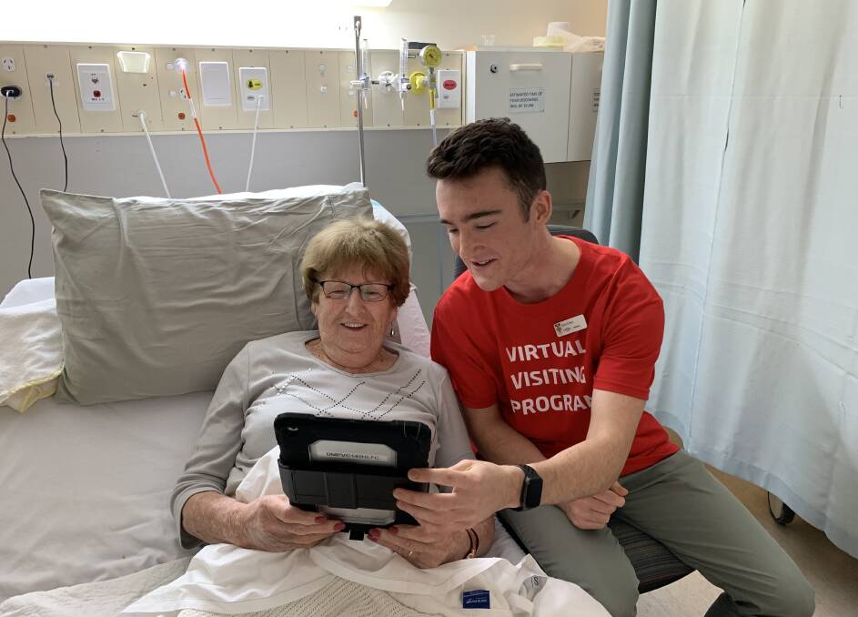 HELPING HAND: Patient Carmel Mooney speaks to family and friends virtually with the help of medical student is Kyle Green as part of the pilot Virtual Visiting Program at Albury Wodonga Health. 