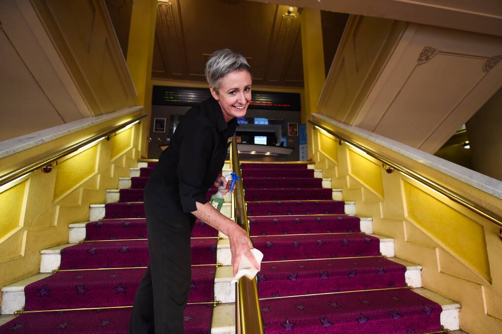 NO GO: Team leader Jodie Goss cleaning hand rails prior to the lockdown which forced the Regent Cinemas Albury to close its doors. Picture: MARK JESSER