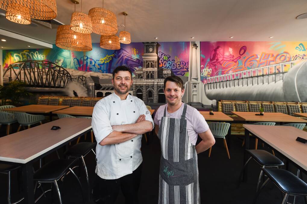 WELCOME: Andrew Milton and Joel Carey in front of the new Albury-inspired mural in their new business 2640 Restaurant and Bar. Picture: MARK JESSER