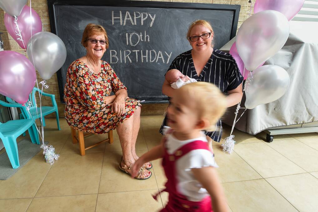 SMILES: Volunteer Colleen Jensen with Grace Opie who used the room when her son Thomas was born nine weeks premature. Ellie McGuire 22 months plays during the celebrations on Tuesday. Picture: MARK JESSER