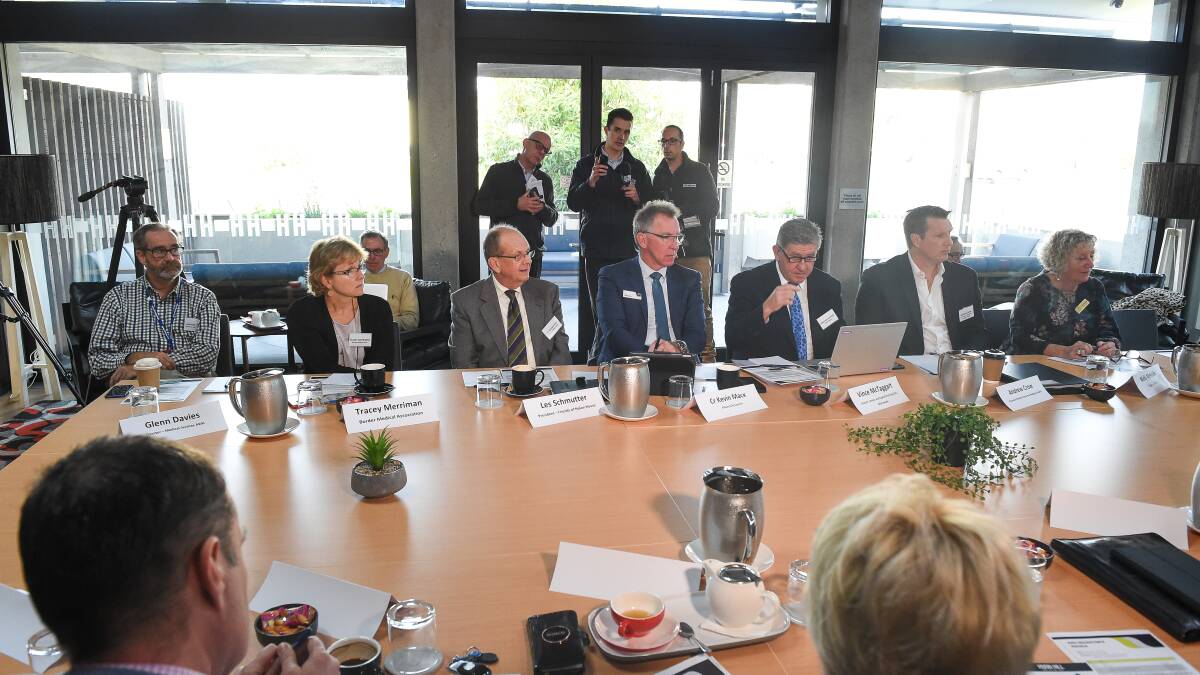 Les Schmutter (centre) during a health round table in June.