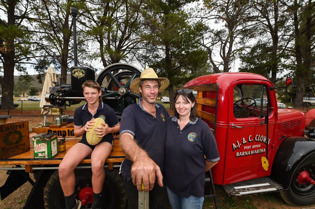 FAMILY: Billy, 15, with parents Ash and Cass Clowes of Barnawartha with their 1919 Ronaldson Bros and Tippett oil engine on the back of a 1948 KC Bedford, 30cwt truck. Picture: MARK JESSER